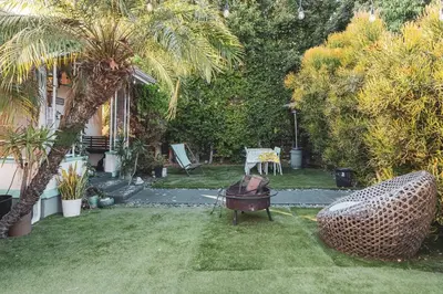 a backyard with a grill and a palm tree at Modern & Airy Silver Lake 2bedroom 2 bath Front House in Los Angeles