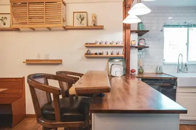 a kitchen with a wooden table and a counter top at Modern & Airy Silver Lake 2bedroom 2 bath Front House in Los Angeles