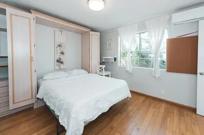 a bedroom with a large white bed and windows at Modern & Airy Silver Lake 2bedroom 2 bath Front House in Los Angeles
