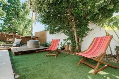 two lawn chairs and a bench in a yard at Serene Silver Lake 1 bedroom 1 bathroom Back house With Private Backyard in Los Angeles