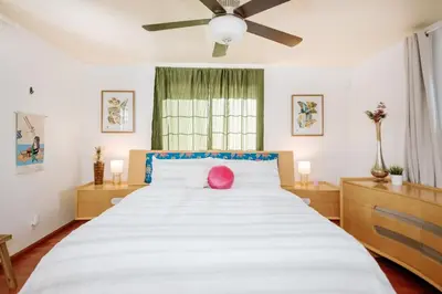 a bedroom with a large white bed with a pink pillow on it at Serene Silver Lake 1 bedroom 1 bathroom Back house With Private Backyard in Los Angeles