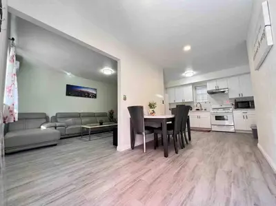 a kitchen and living room with a table and chairs at Hacienda New Remodeled 17miles-Disney in Hacienda Heights