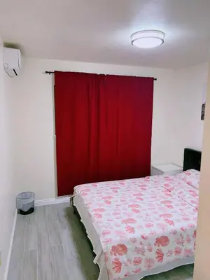 a bedroom with a bed with a red curtain at Hacienda New Remodeled 17miles-Disney in Hacienda Heights
