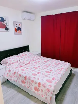 a bedroom with a bed with a red curtain at Hacienda New Remodeled 17miles-Disney in Hacienda Heights