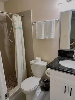 a white bathroom with a toilet and a sink at Hacienda New Remodeled 17miles-Disney in Hacienda Heights
