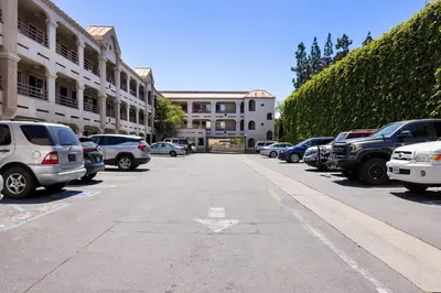 a street with cars parked in a parking lot at Paradise Lodge - Canoga Park, Los Angeles in Winnetka