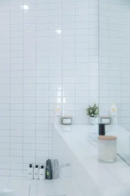 a bathroom with white tiled walls and a counter with a plant at Industrial&Stylish 3 bedroom 3 bathrooms Home With Views and Hot tub in Los Angeles