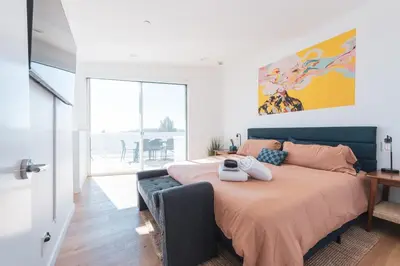 a bedroom with a large bed and a large window at Industrial&Stylish 3 bedroom 3 bathrooms Home With Views and Hot tub in Los Angeles