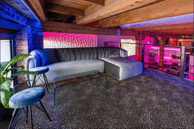 a living room with a couch and pink and purple lighting at Arts District DTLA-Artist Loft With Free Parking and Pooltable in Los Angeles