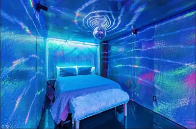 a bedroom with a bed in a room with lasers at Arts District DTLA-Artist Loft With Free Parking and Pooltable in Los Angeles
