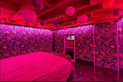 a bedroom with pink lighting and a bed in it at Arts District DTLA-Artist Loft With Free Parking and Pooltable in Los Angeles