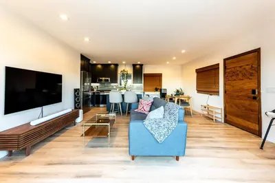 a living room with a blue couch and a tv at Hidden Oasis 3 bedroom 2 bathroom Home With large backyard and Views Near DTLA in Los Angeles