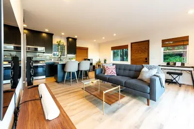 a living room with a couch and a kitchen at Hidden Oasis 3 bedroom 2 bathroom Home With large backyard and Views Near DTLA in Los Angeles