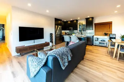 a living room with a couch and a kitchen at Hidden Oasis 3 bedroom 2 bathroom Home With large backyard and Views Near DTLA in Los Angeles