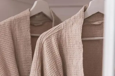 a group of shirts hanging on a rack at Renovated Stylish Guesthouse By Claremont With Private Patio in Montclair