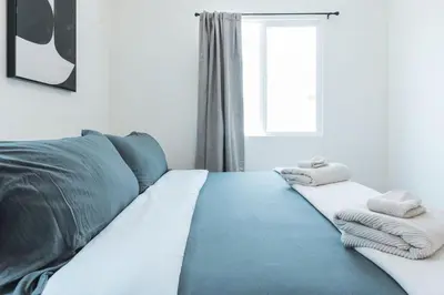 a living room with a blue couch and a window at Renovated 1 Bedroom 1 bathroom Cottage Near Larchmont Village in Los Angeles