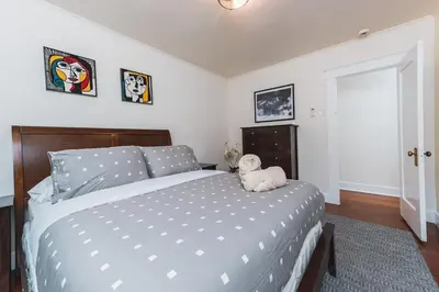 a teddy bear sitting on a bed in a bedroom at Charming Vintage 2 bedroom 1 Bathroom Close to Larchmont Village in Los Angeles