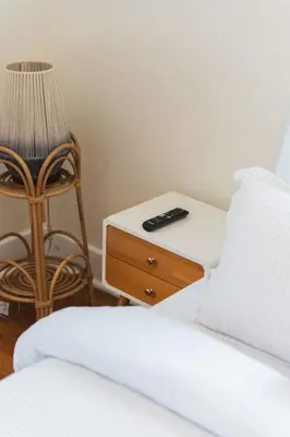 a bedroom with two beds and a table with a remote control at Quaint Updated 2 bedroom 1 bathroom Cottage Near Larchmont Village in Los Angeles