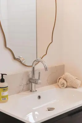 a bathroom sink with a mirror above it at Quaint Updated 2 bedroom 1 bathroom Cottage Near Larchmont Village in Los Angeles