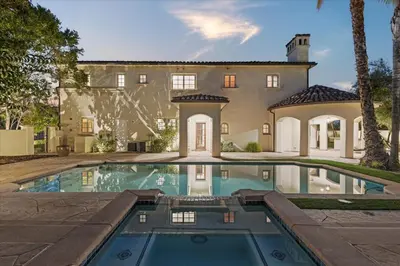 an exterior view of a house with a swimming pool at 5800 sq ft Gorgeous Tarzana 7 bedroom 9 bathroom home with pool and hot tub in Tarzana