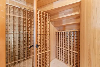 a wine cellar with wooden walls and a glass door at 5800 sq ft Gorgeous Tarzana 7 bedroom 9 bathroom home with pool and hot tub in Tarzana