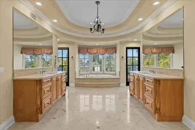 a large kitchen with two sinks and windows at 5800 sq ft Gorgeous Tarzana 7 bedroom 9 bathroom home with pool and hot tub in Tarzana