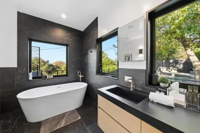 a bathroom with a large white tub and a sink at Farley Court in Los Angeles
