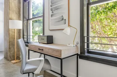 an office with a desk and a chair and a window at Blueground Historic Core view nr Grand Park LAX-1424 in Los Angeles