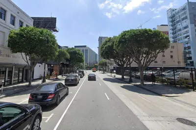 a city street with cars driving down the street at Blueground Historic Core view nr Grand Park LAX-1424 in Los Angeles