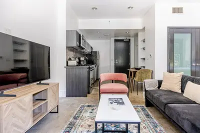 a living room with a couch and a tv at Blueground Historic Core view nr Grand Park LAX-1424 in Los Angeles