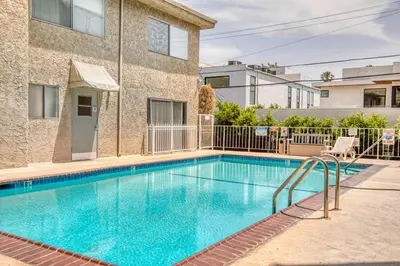 a swimming pool in front of a building at Blueground Melrose pool nr Griffith Park LAX-1399 in Los Angeles