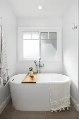 a white bath tub in a bathroom with a window at Naples Island Stunning Ocean Cottage By the Beach in Long Beach