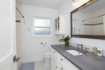 a white bathroom with a sink and a mirror at Naples Island Stunning Ocean Cottage By the Beach in Long Beach