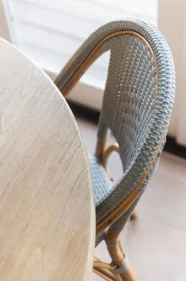 a wicker chair sitting next to a table at Naples Island Stunning Ocean Cottage By the Beach in Long Beach