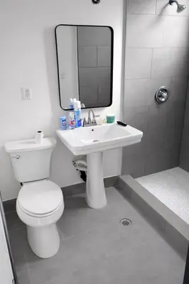 a bathroom with a toilet and a sink and a mirror at La Cienega Soul in Los Angeles
