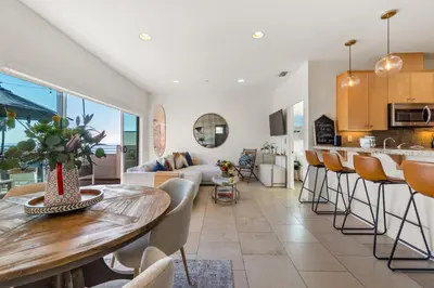a kitchen and living room with a table and chairs at Ocean View condo in the heart of Manhattan Beach in Manhattan Beach