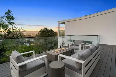 a patio with couches and a table on a deck at Hollywood Hills Retreat - Next to Universal Studios in Los Angeles