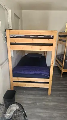 a bunk bed in a room with a purple mattress at The Vibe in Los Angeles