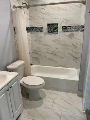 a bathroom with a tub and a toilet and a sink at The Vibe in Los Angeles
