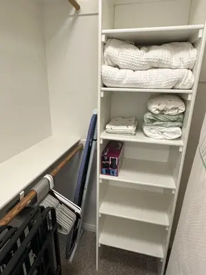 a closet with white shelves and folded towels at Spacious 2B 2B Pool View Loft Apartment in Marina Del Rey in Los Angeles