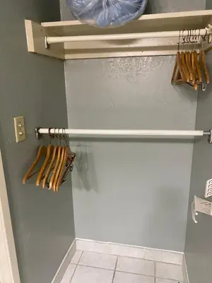 a closet with wooden baseball bats on a wall at Hiltop Hotel in Bakersfield