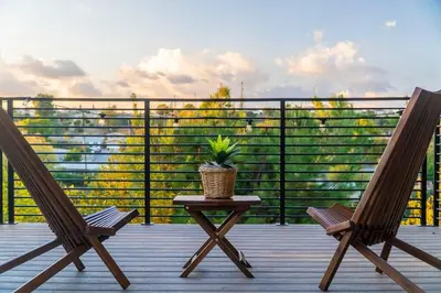 two chairs and a table on a balcony with a plant at Cozy Comfort LA House with Stunning Scenic Views in Monterey Park