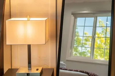a lamp sitting on a table next to a window at Cozy Comfort LA House with Stunning Scenic Views in Monterey Park