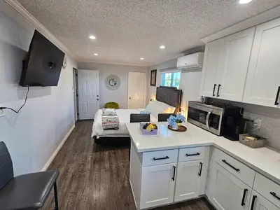 a kitchen with a living room and a room with a couch at Cozy Comfort LA House with Stunning Scenic Views in Monterey Park