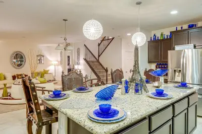 a kitchen with a table with blue dishes on it at 4 Mi to CSUB Campus Spacious Home with Yard in Bakersfield