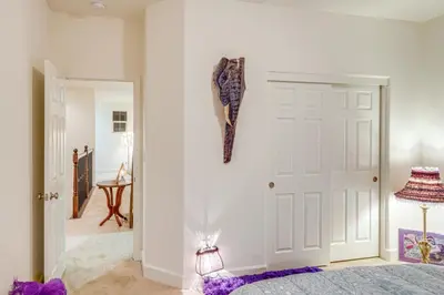 a bedroom with a bed and a white door at 4 Mi to CSUB Campus Spacious Home with Yard in Bakersfield