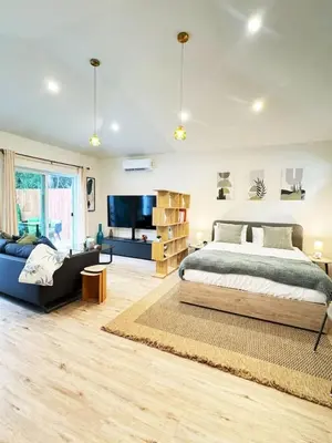 a bedroom with a bed and a couch and a tv at Chic Studio Haven by Century City - FH2 - BV in Los Angeles