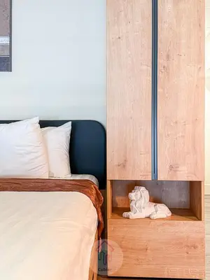 a bedroom with a bed and a wooden cabinet at Sleek 1BR Loft in Luxury High-Rise - 103 - GL in Glendale
