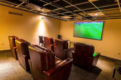 a room with leather chairs and a flat screen tv at Sleek 1BR Loft in Luxury High-Rise - 103 - GL in Glendale