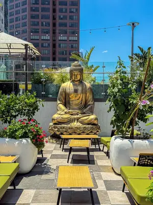 a large statue of a buddha sitting on a patio at Sleek 1BR Loft in Luxury High-Rise - 103 - GL in Glendale